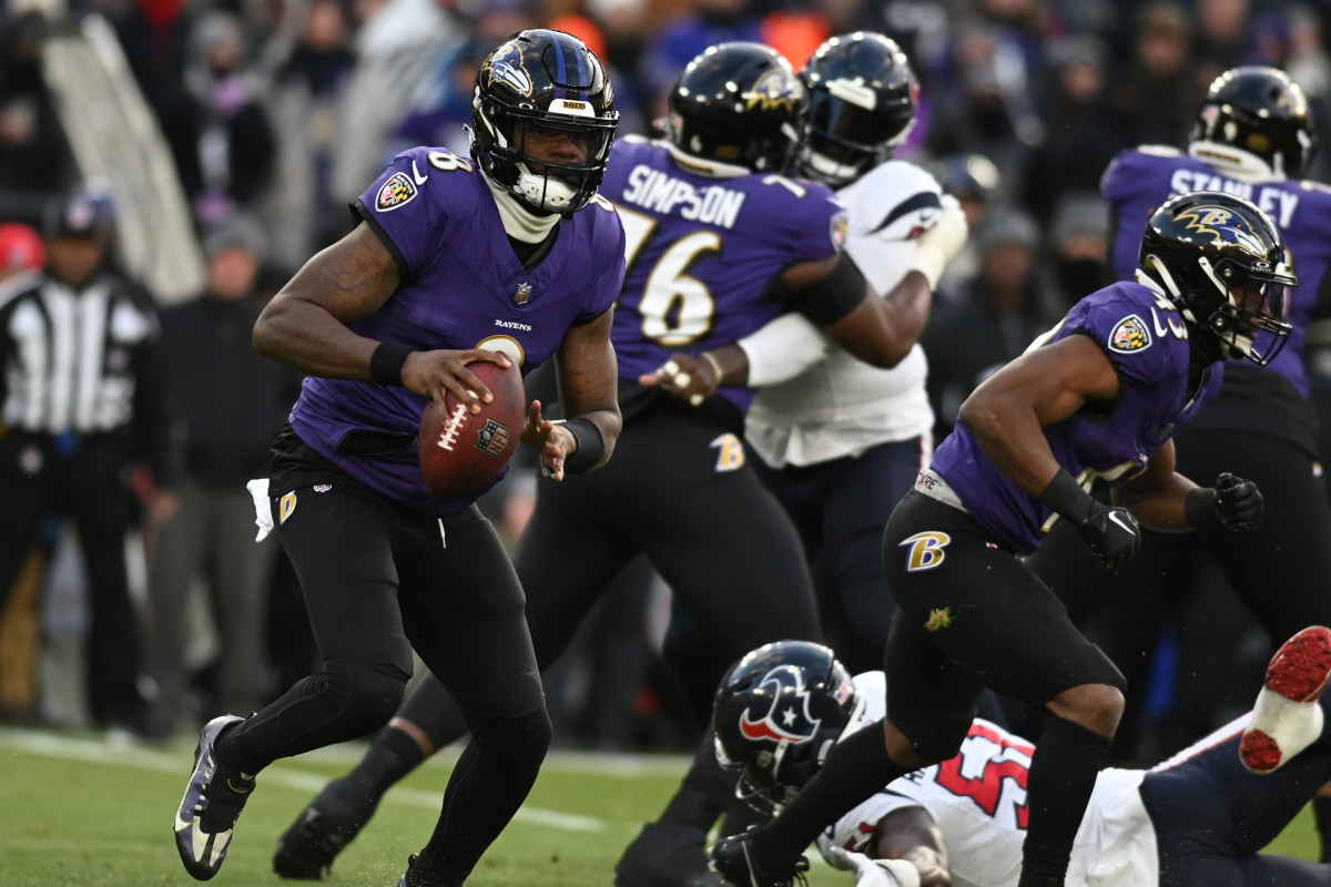 Jan 20, 2024; Baltimore, MD, USA; Baltimore Ravens quarterback Lamar Jackson (8) runs the ball against the Houston Texans in the first quarter of a 2024 AFC divisional round game at M&T Bank Stadium. 